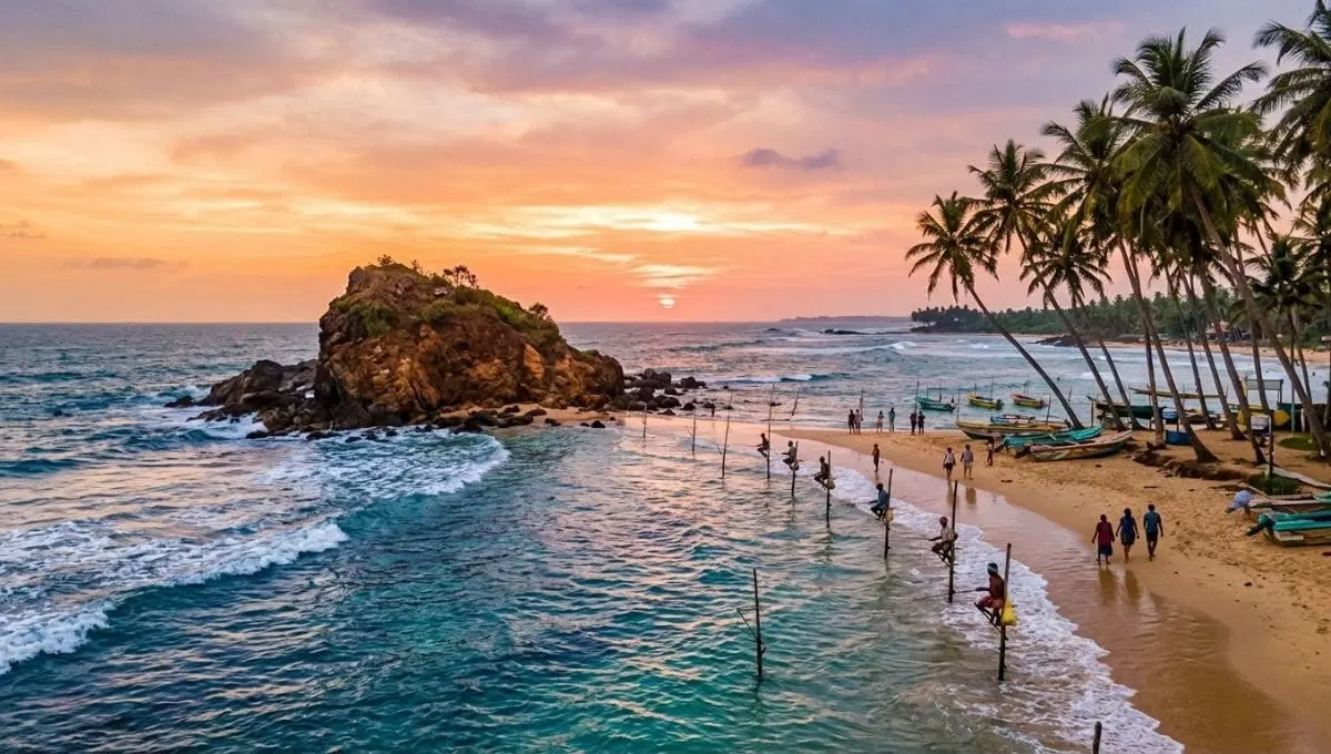 Sunset over Mirissa with Parrot Rock, stilt fishermen and palm trees